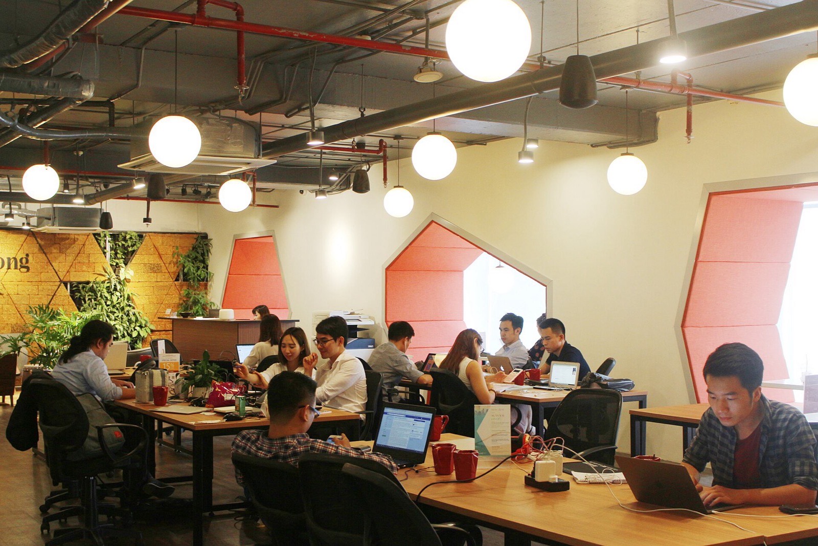The Kwashly team working together at laptops around a table