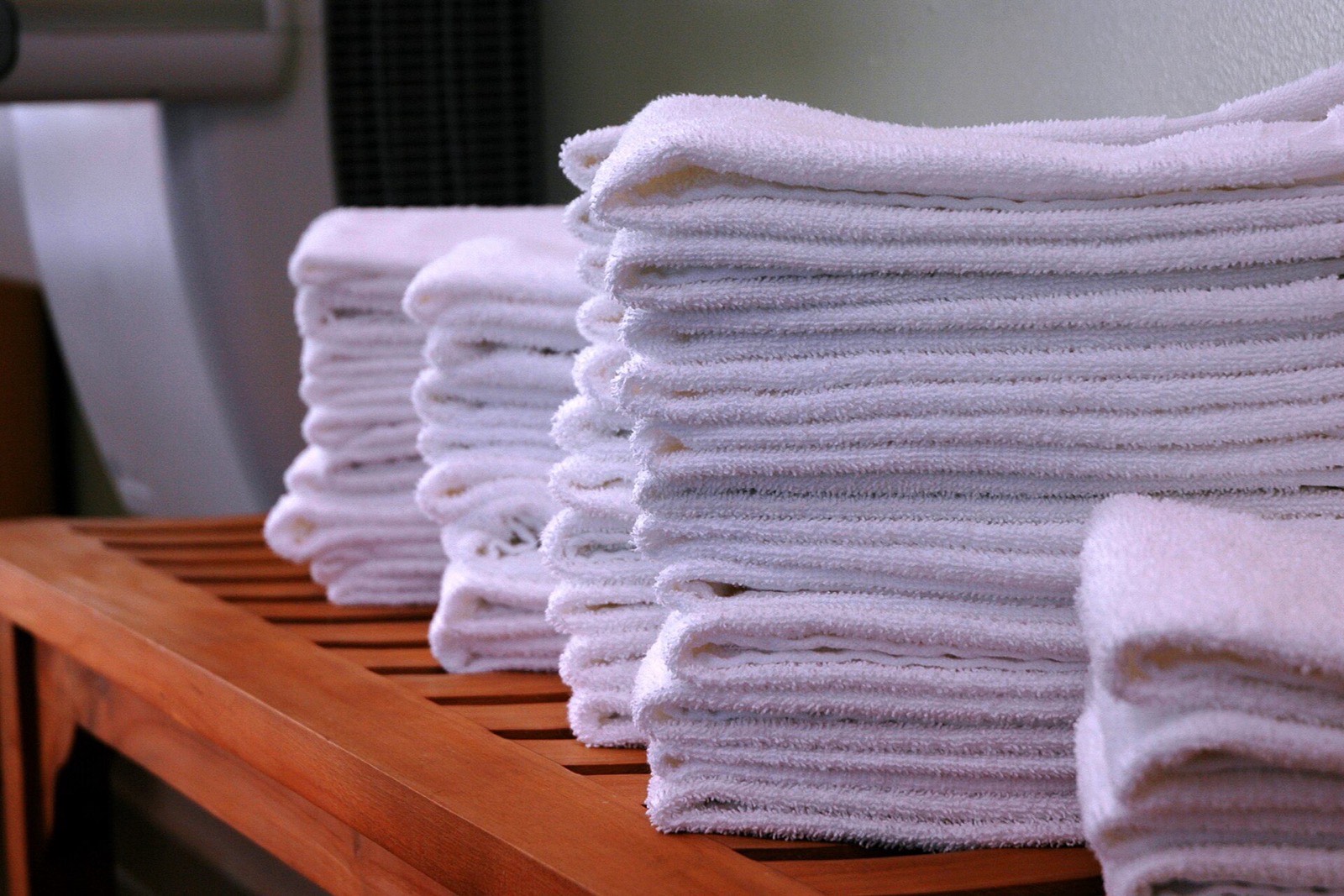 Neatly folded clean laundry stacked in piles